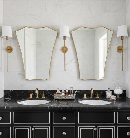Pair of shield brass mirrors over double bathroom vanity