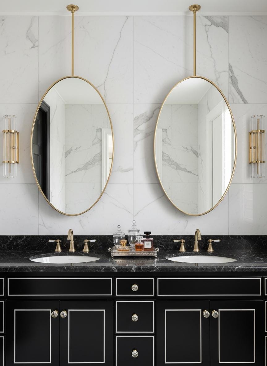 Double oval brass hanging mirrors over black vanity
