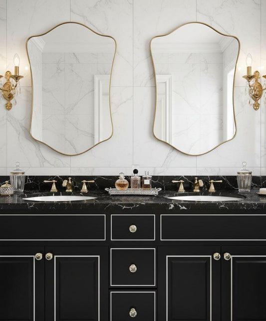 Pair of irregular brass vanity mirrors in luxury bathroom