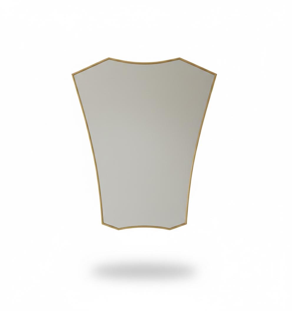 Shield brass wall mirror in a white background
