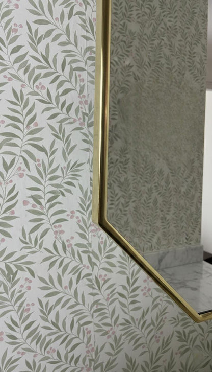 Slim brass frame profile against patterned wallpaper