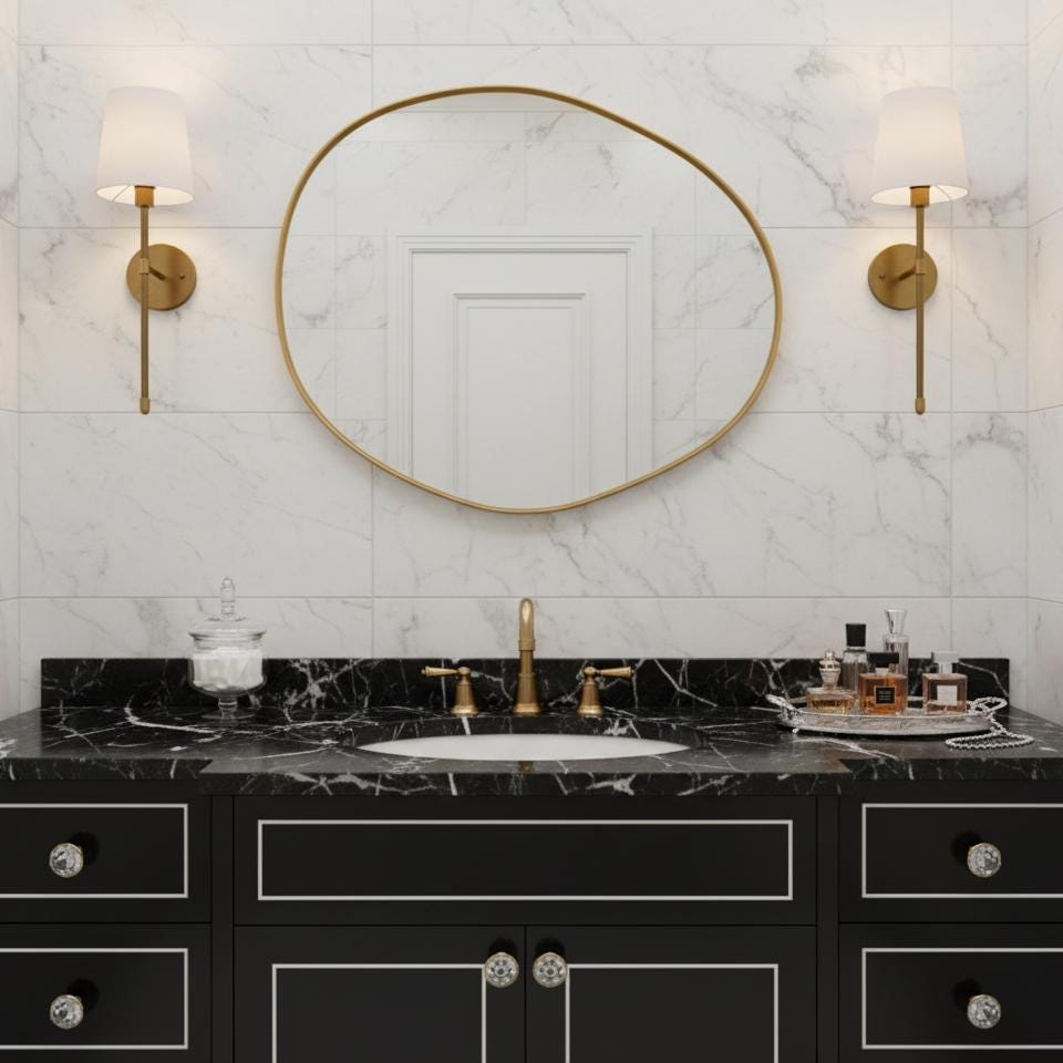 Asymmetrical brass mirror with black vanity bathroom styling