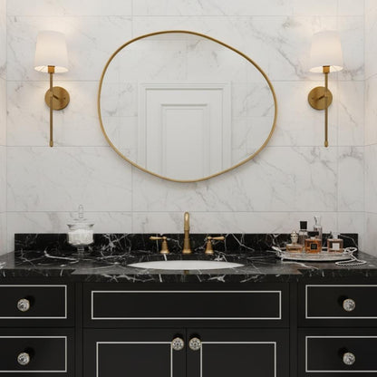 Asymmetrical brass mirror with black vanity bathroom styling