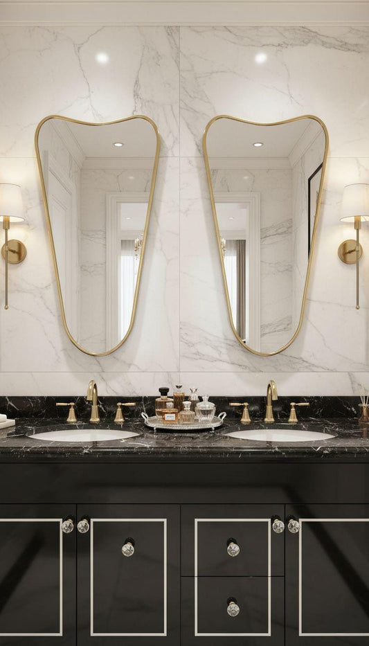 Asymmetrical tapered brass mirror above double bathroom vanity
