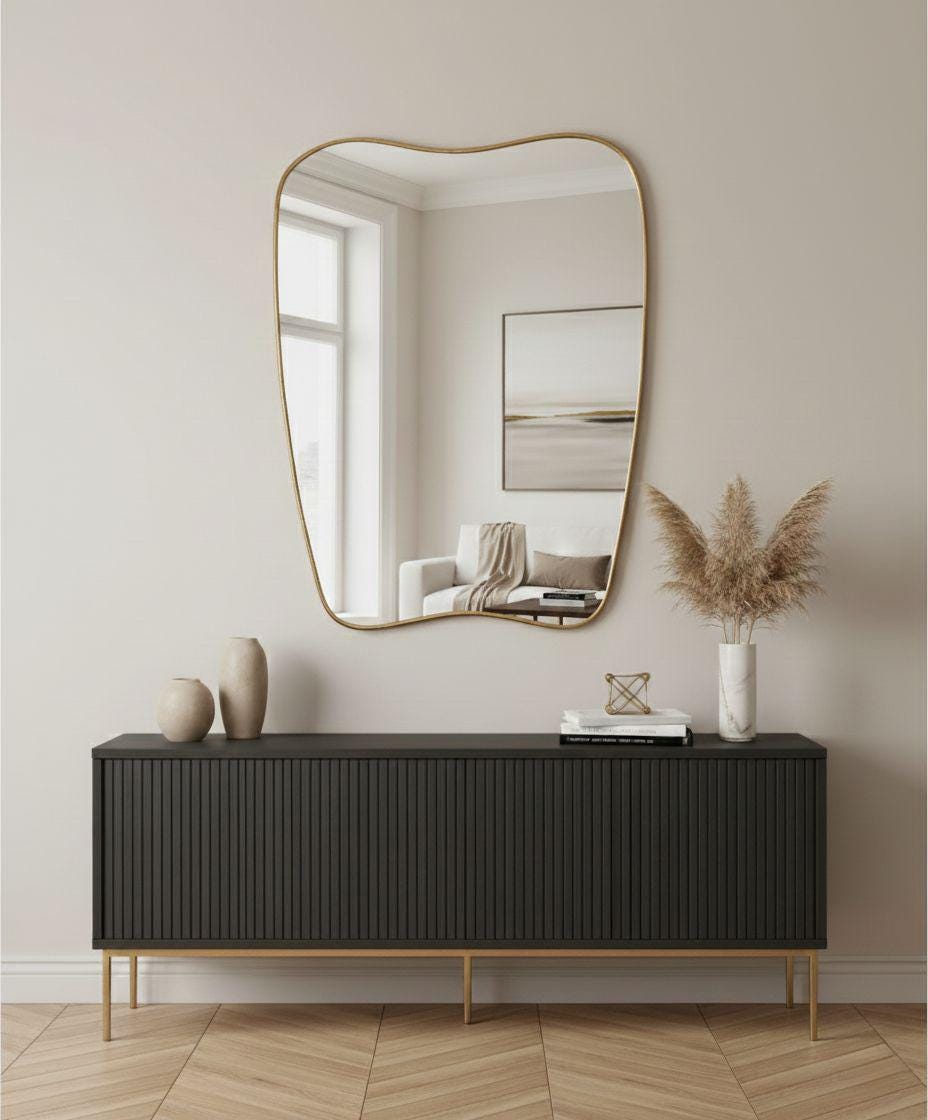 Irregular brass mirror with organic curved frame