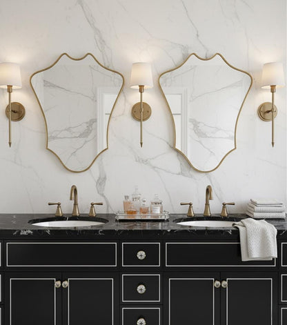 Double curved shield brass mirrors over bathroom vanity
