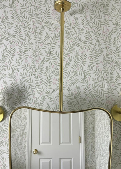 Suspended brass mirror with curved frame detail
