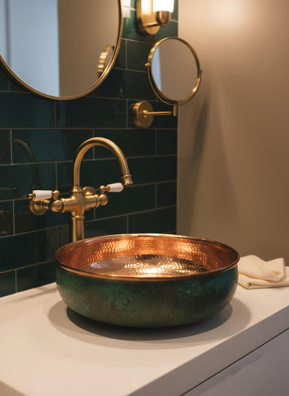 Artisan copper vessel sink with green exterior on marble vanity