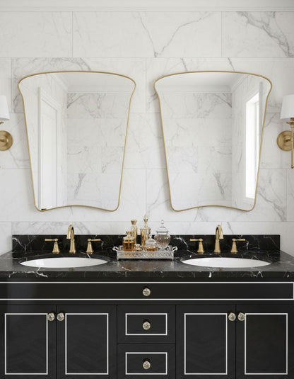 Asymmetrical brass bathroom mirrors over double sink