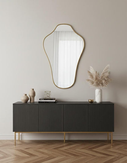 Modern irregular brass wall mirror styled above console