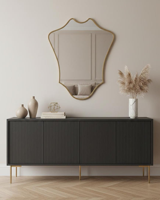 Shield-shaped brass wall mirror in modern interior
