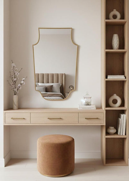 Shield brass mirror over wooden vanity desk in bedroom