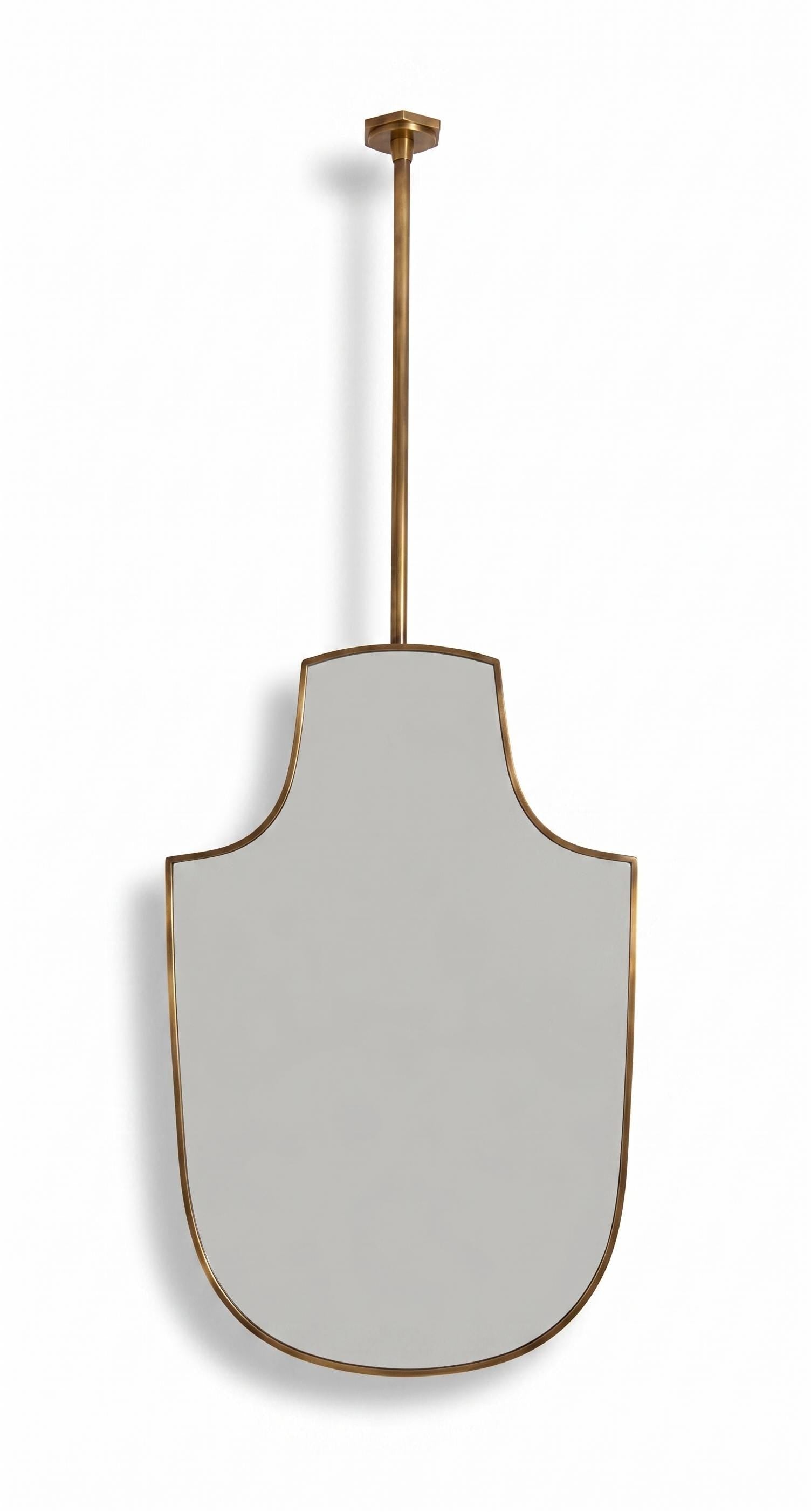 Handmade suspended shield brass mirror with slim unlacquered brass frame