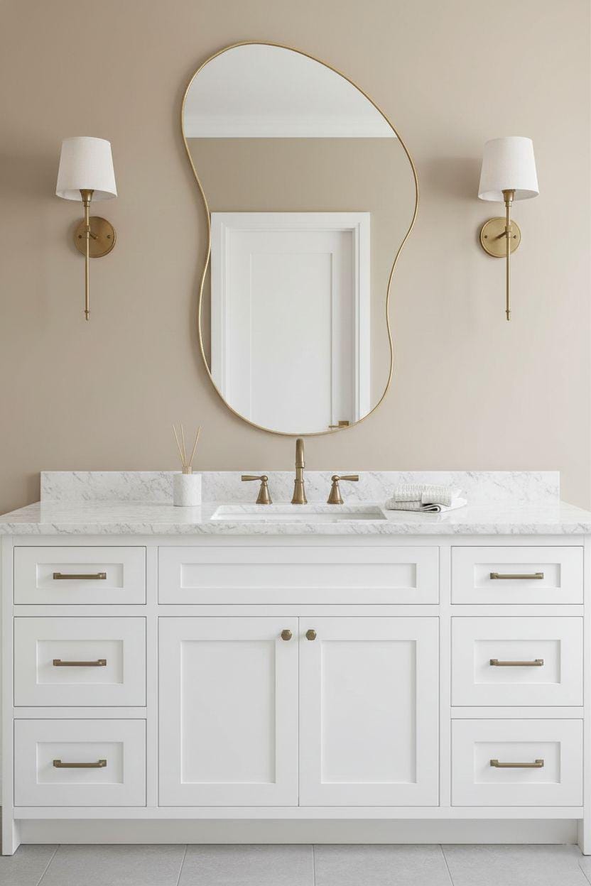 Organic curved brass mirror over white bathroom vanity