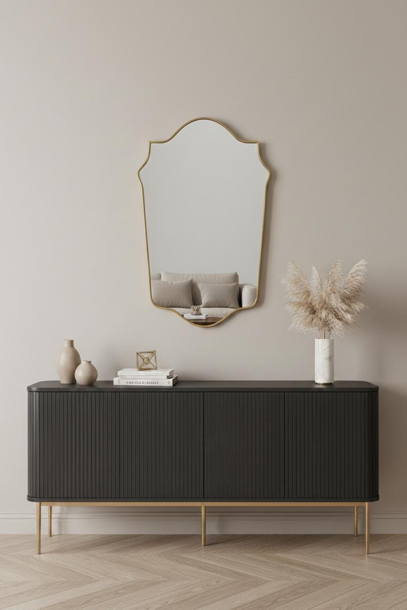 Classic arched crest brass wall mirror above modern console