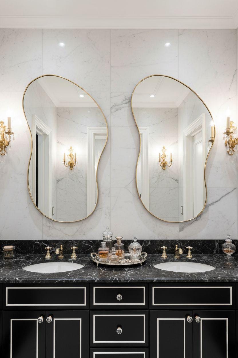 Curved asymmetrical brass bathroom mirrors above double vanity