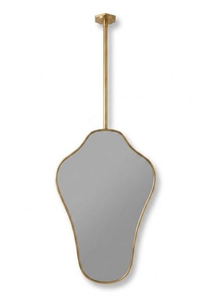 Organic suspended brass mirror on a light neutral background