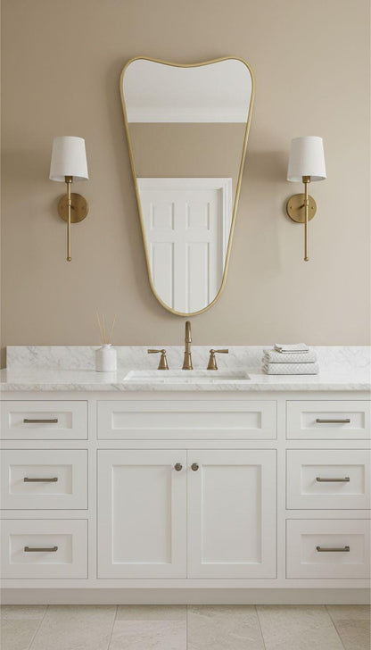 Tapered brass bathroom mirror with curved top and wall sconces