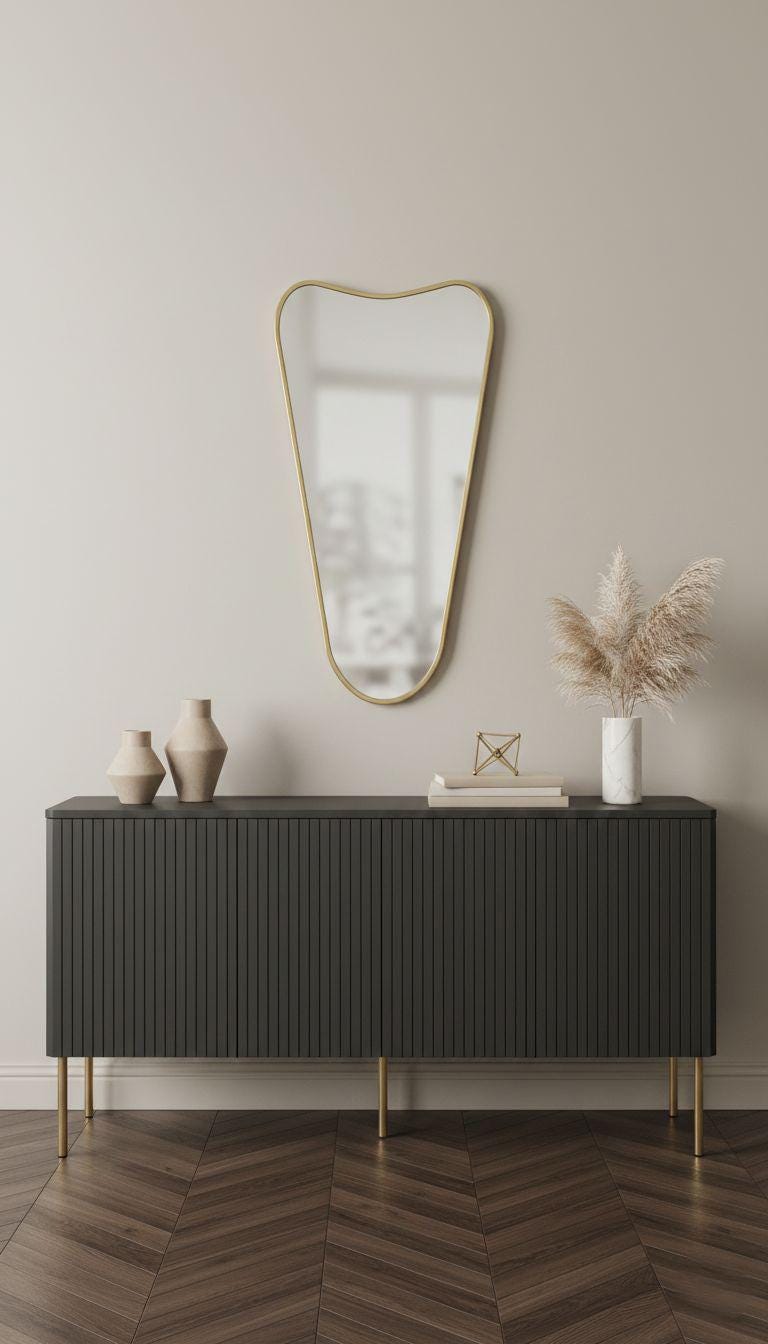 Curved top brass wall mirror in modern entryway interior