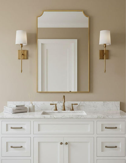 Scalloped brass vanity mirror with wall sconces
