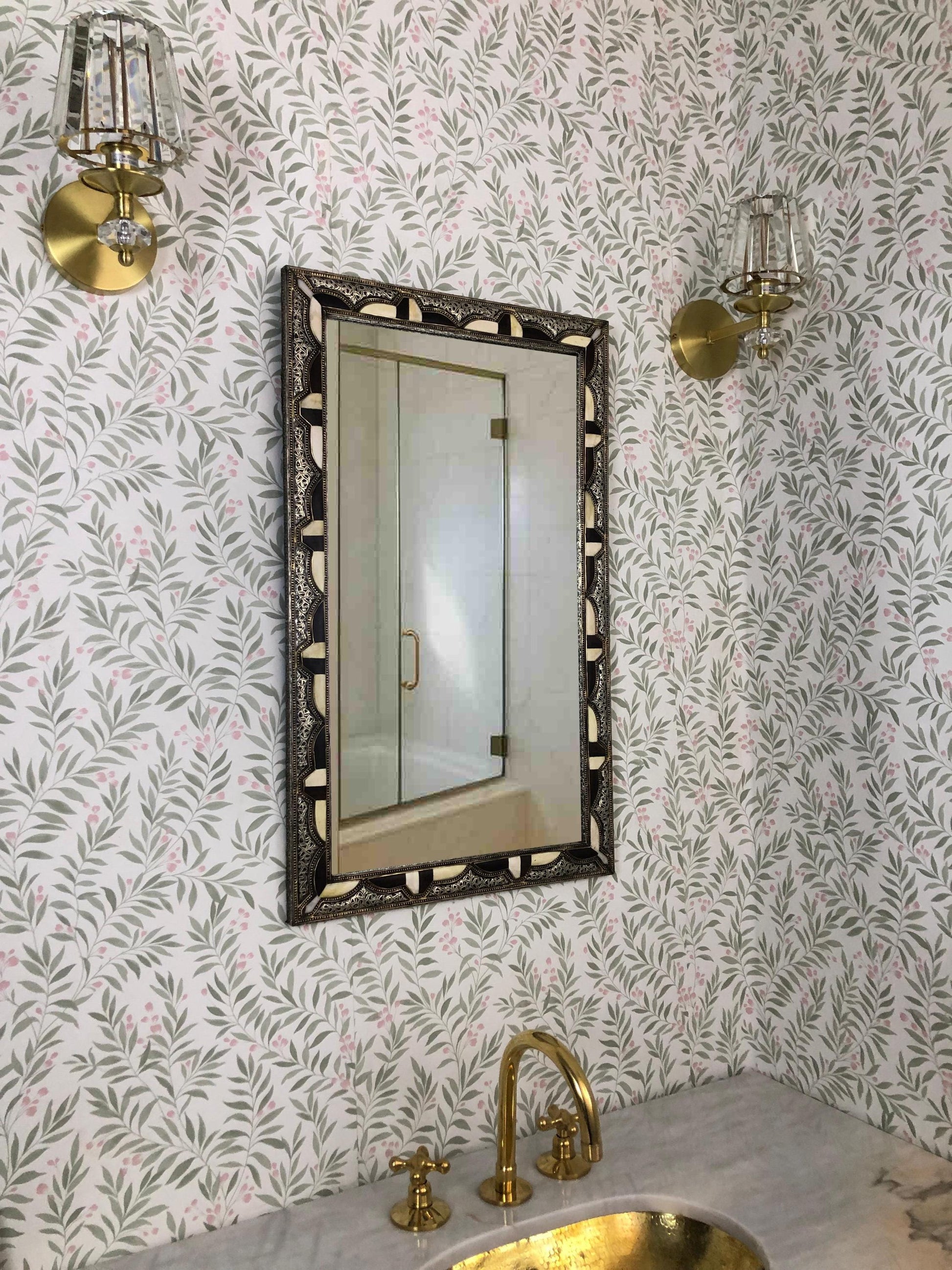 Decorative Bone mirror above gold faucet
