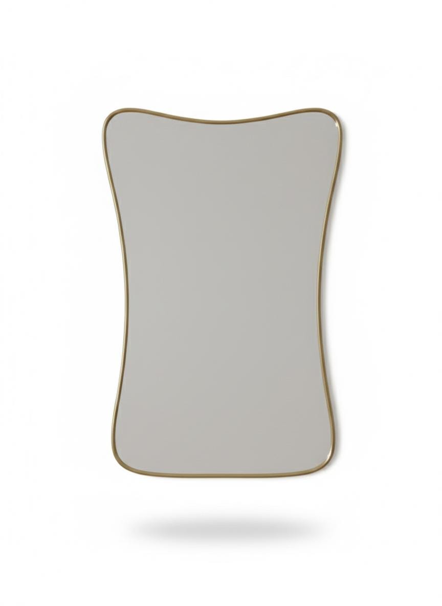 Curved brass mirror in a white background