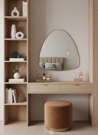 Irregular brass wall mirror above wooden vanity