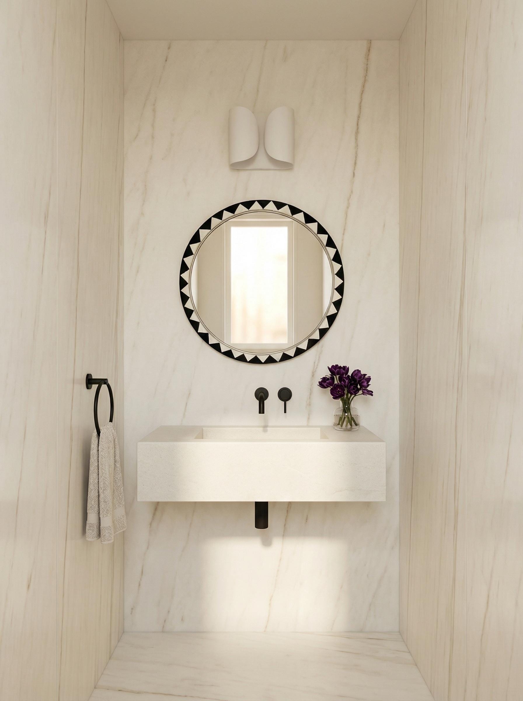 Round Moroccan geometric mirror in minimalist white marble bathroom