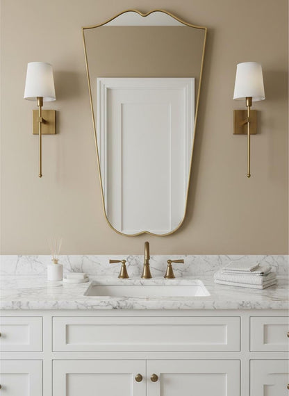 Curved brass bathroom mirror with wall sconces