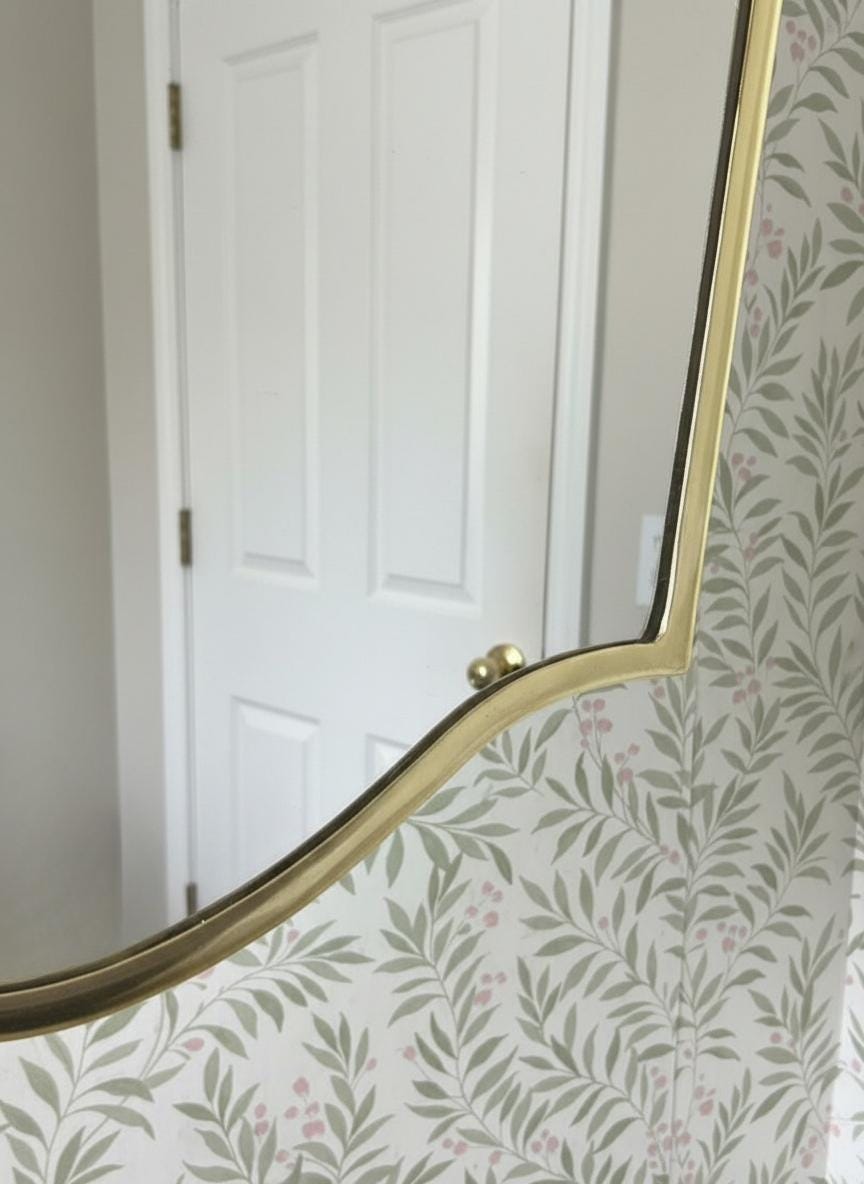 Close-up of brass frame and wallpaper