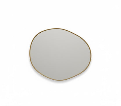 Asymmetrical brass mirror  a white background.