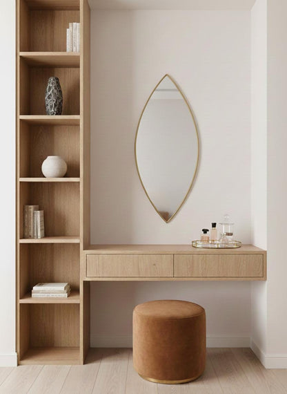 Pointed oval brass mirror in modern dressing nook