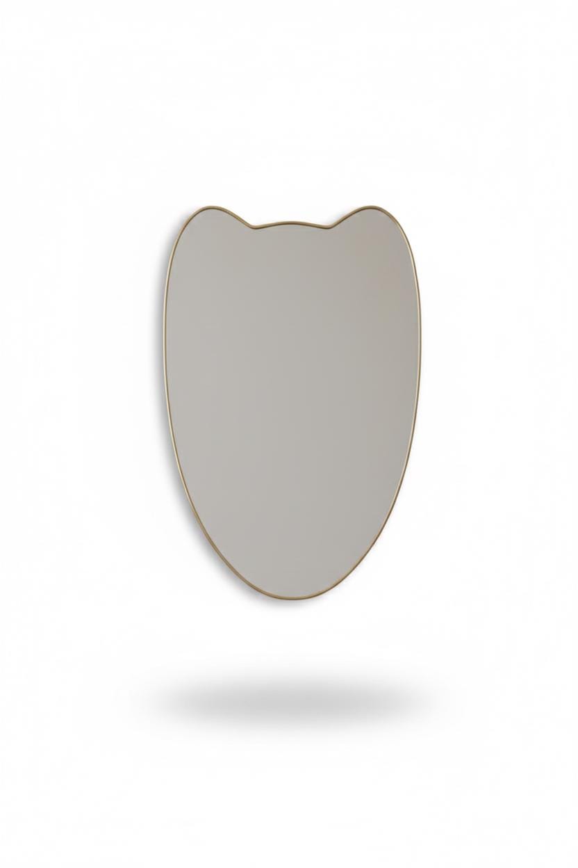 Curved crest brass mirror in a white background.