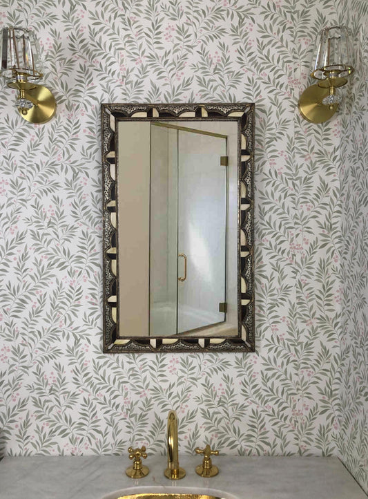 Bone inlay mirror on patterned wall