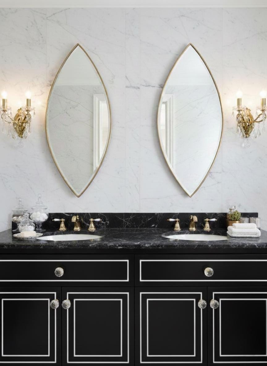 Pair of pointed oval brass mirrors over double vanity