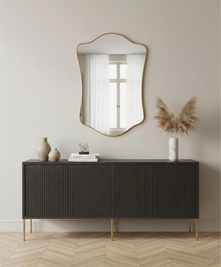 Handmade curved brass mirror styled over modern console