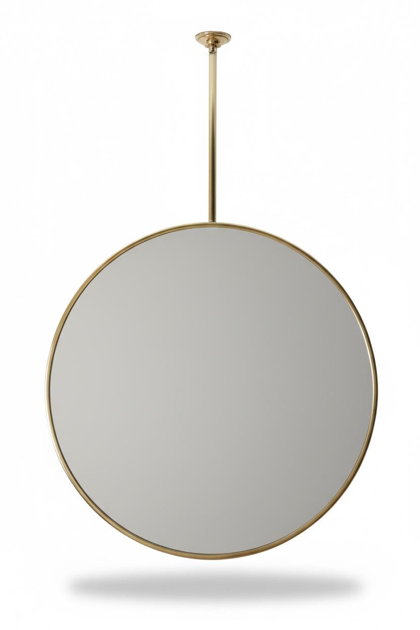 Ceiling mounted round brass mirror on white background