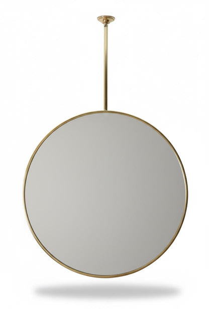 Ceiling mounted round brass mirror on white background