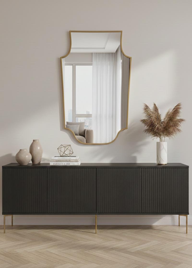 Handmade shield brass mirror styled above modern sideboard