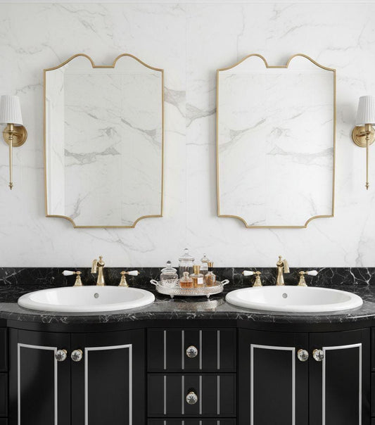 Double vanity setup with matching scalloped brass wall mirrors