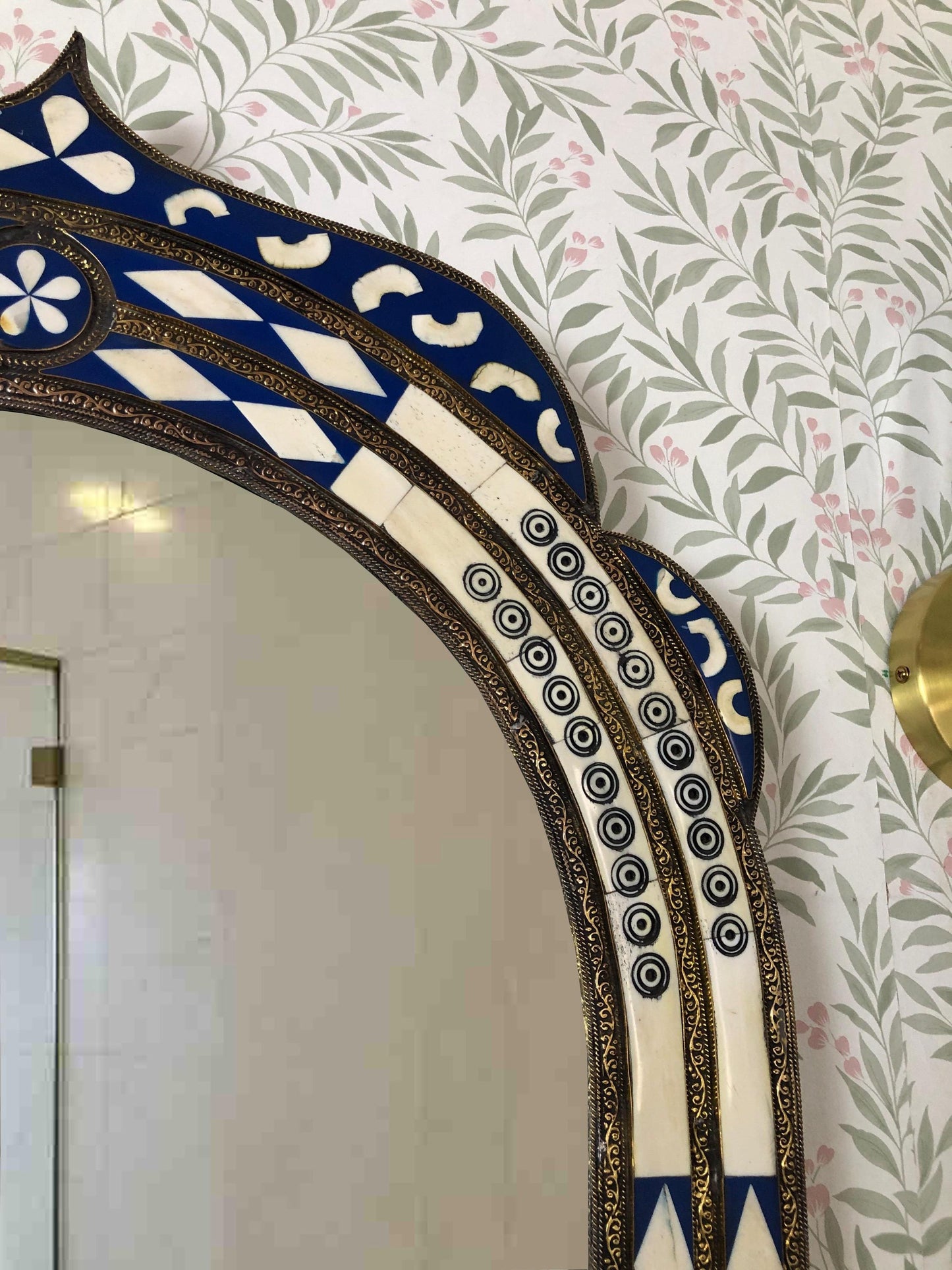 Side detail of arched mirror with patterned inlay.