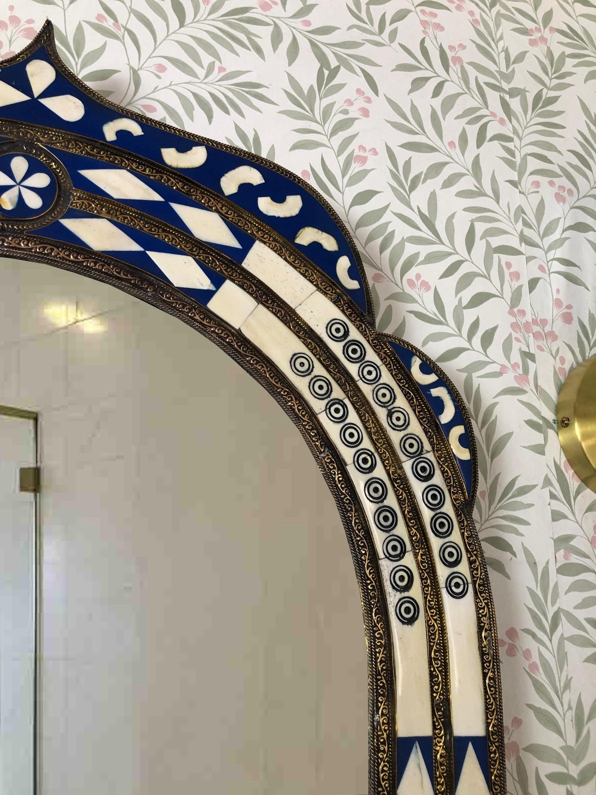 Side detail of arched mirror with patterned inlay.