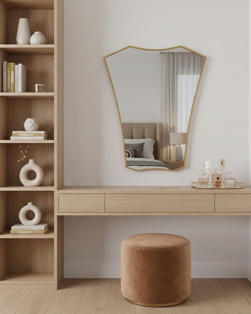 Shield brass mirror above wooden vanity table