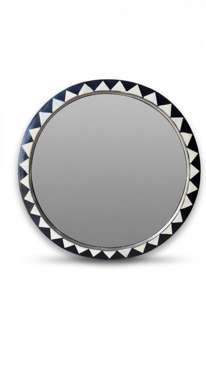 Close-up of Moroccan round mirror with black and white triangle inlay detail