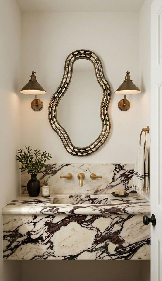 Artisan bone inlay mirror over marble vanity with brass sconces
